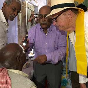 John Hurckman looking at and Indian male patient with Dr. Chandra