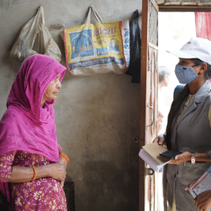 In India, a Shakti worker screens a patient in her home.